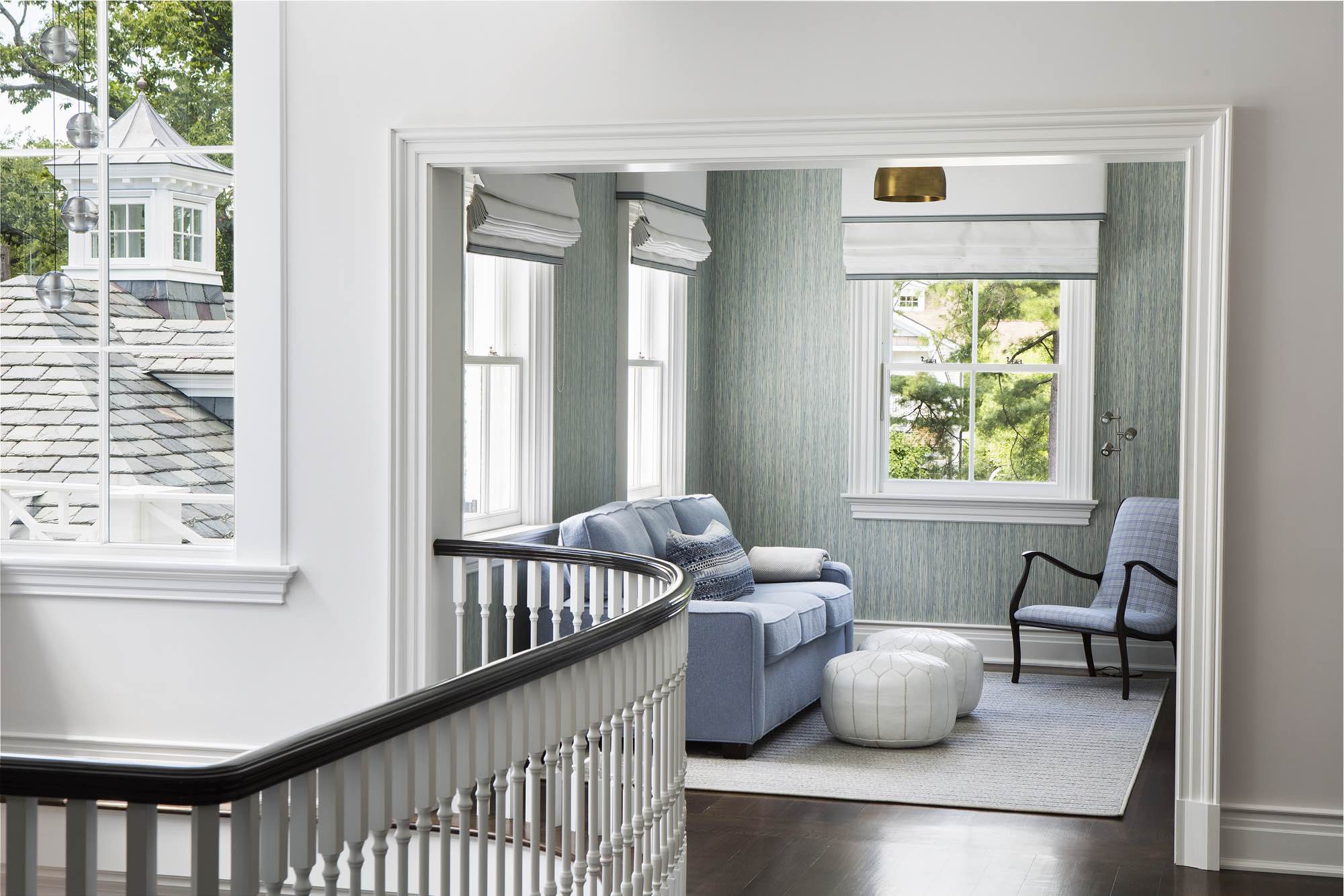 Sitting area at the top of the stairs in a colonial style house.