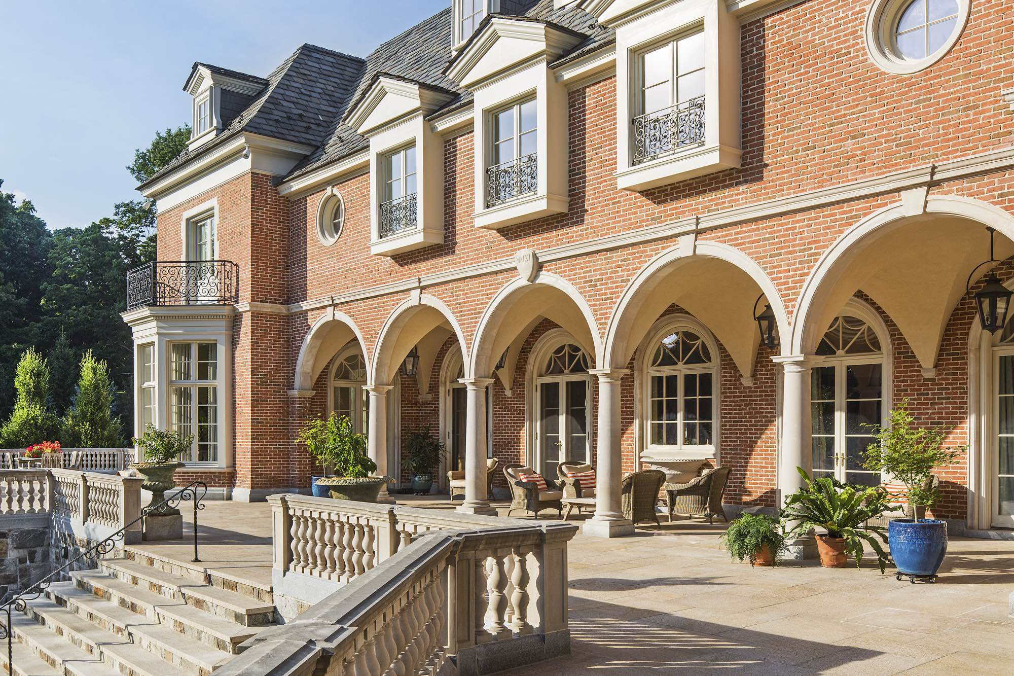 The vaulted west-facing loggia can be accessed from the kitchen, breakfast, dining, and living rooms.